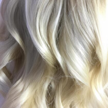 Platinum blonde hair with seamless highlights and soft waves - Millionaire Hair Salon Winter Garden FL