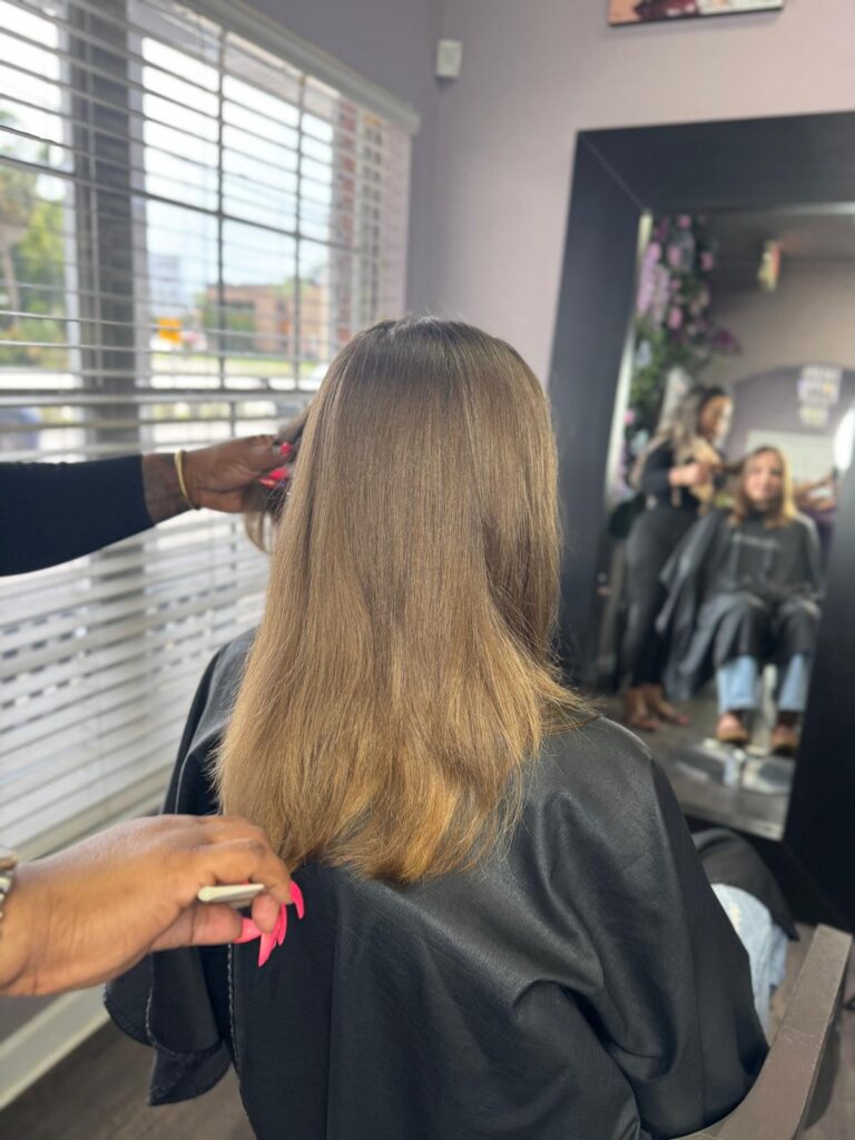 Client hair blowout and straightening service at Millionaire Hair Salon Winter Park FL